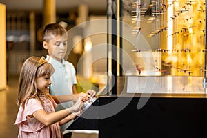 Little boy and girl studying physics in science museum