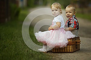 Little boy and girl with suitcase