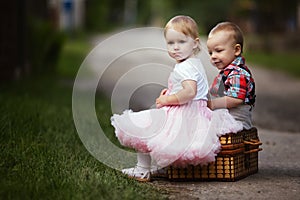 Little boy and girl with suitcase