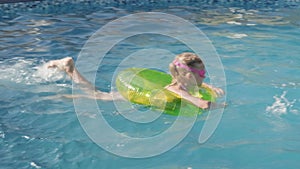 Little boy and girl swimming in swimming pool, children having fun, splashing water. Summer travel family hotel vacation