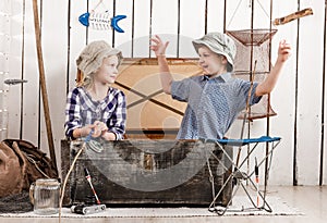 Little boy and girl talk sitting in chest