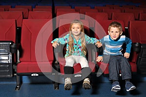 Little boy and girl together watching a movie