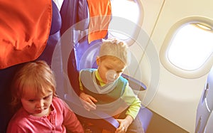 Little boy and girl travel by plane