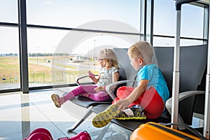 Little boy and girl waiting for boarding on the airport