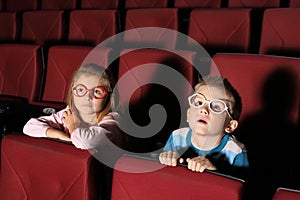 Little boy and girl watching a movie with interest