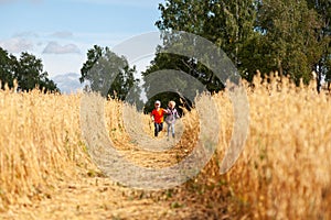 Little boy and girl on a wheat field