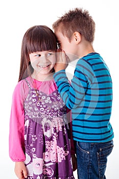 Little boy and girl whispering