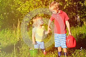 Little boy and girl working in the garden