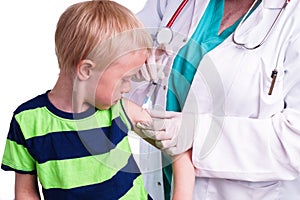 Little boy is given an injection by the family doctor