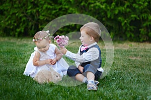 Little boy gives a girl a bouquet of flowers