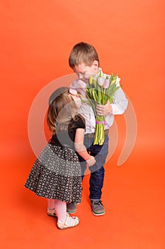 Little boy gives a girl a bouquet of flowers