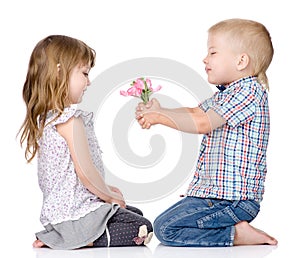 The little boy gives to the girl a flower. isolated on white