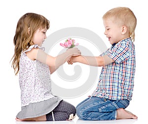 The little boy gives to the girl a flower. on white