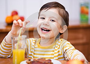 Little boy with glass of orange juice