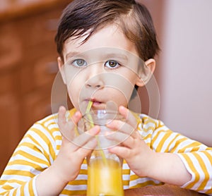 Little boy with glass of orange juice