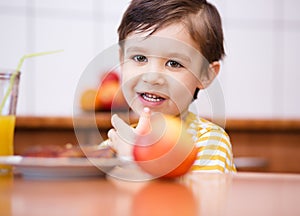 Little boy with glass of orange juice