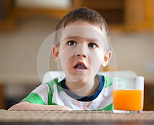 Little boy with glass of orange juice