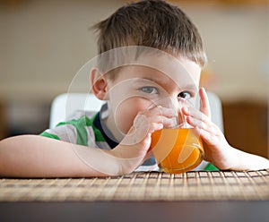 Little boy with glass of orange juice