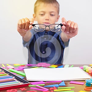 little boy with glasses correcting myopia close-up portrait Ophthalmology problem selective focus