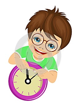 Little boy with glasses showing arrows on the wall clock