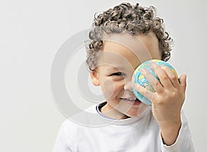 Little boy with globe in his hand with white background stock photo