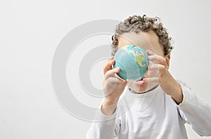 Little boy with globe in his hand with white background stock photo