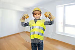 little boy in gloves, safety vest and helmet