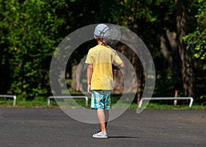 Little boy  goes to play badminton with badminton rackets in the back