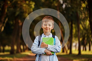 Little boy going back to school. Child with backpack and books.