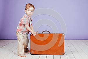 Little boy going on a journey with suitcase