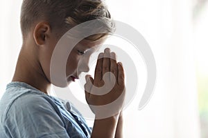 Little boy with hands clasped together