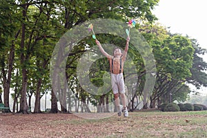 Little boy happy smiling and playing outdoor. Lovely boy running on meadow smiling and jumping, stop motion shot