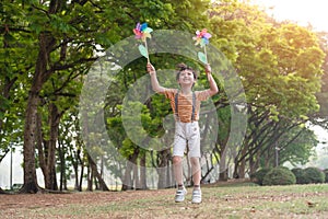 Little boy happy smiling and playing outdoor. Lovely boy running on meadow smiling and jumping, stop motion shot