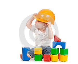 Little boy with hard hat and building blocks