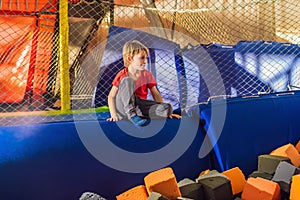 Little boy have fun jumping on trampolines