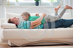 Little boy having fun with father at home photo