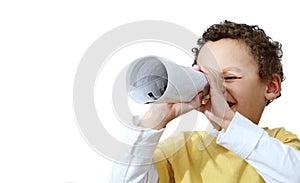 Little boy having fun with newspaper that he has previously read