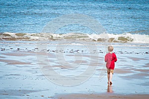 A little boy having fun playing in the sea