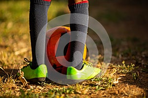 Little boy having fun playing a soccer football game on summer day. Active outdoors game sport for children.