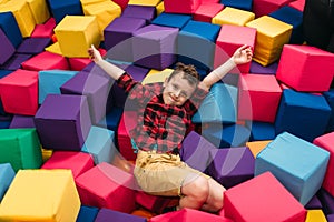 Little boy having fun with soft colorful cubes