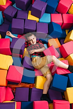 Little boy having fun with soft colorful cubes