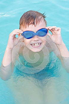 The little boy having good time in the swimming pool