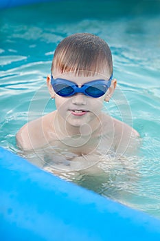 The little boy having good time in the swimming pool