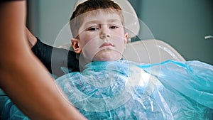 A little boy having his teeth done - putting on safety cover