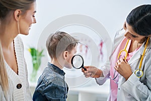 Little boy having medical examination by dermatologist