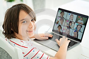 Little boy having online school distance learning class at home