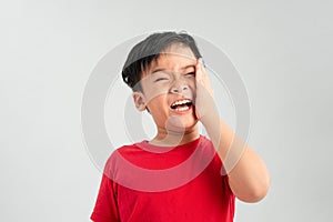 Little boy having toothache. Emotional portrait of asian boy suffering. Sad child with tooth pain. Dental problem