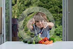 Little boy having vegetable meal