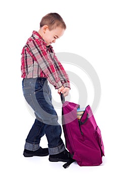 Little boy with heavy schoolbag