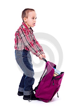 Little boy with heavy schoolbag photo